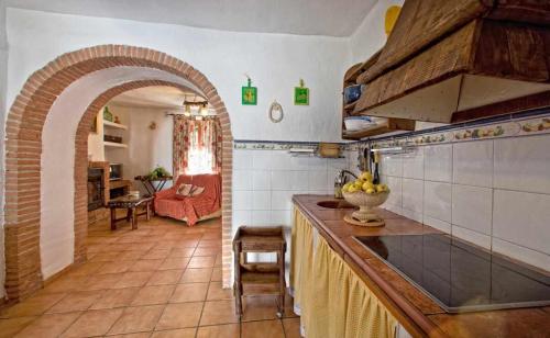 a kitchen with a counter and an archway in a room at Cortijo La Gineta in Alcalá la Real