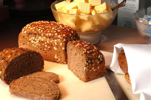 a table with bread and butter and a bowl of butter at IntercityHotel Berlin Hauptbahnhof in Berlin