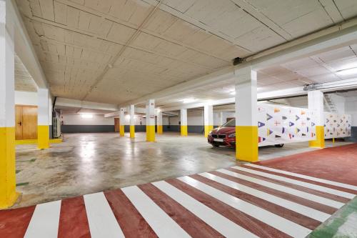 an empty parking garage with a car parked in it at Hotel Juan de la Cosa in Santoña