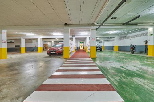 a parking garage with a red and white stripe on the floor at Hotel Juan de la Cosa in Santoña