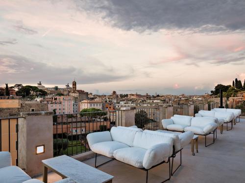 a row of white couches sitting on top of a roof at Rhinoceros in Rome