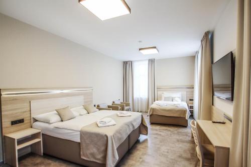 Voodi või voodid majutusasutuse Hotel Mariel Znojmo toas