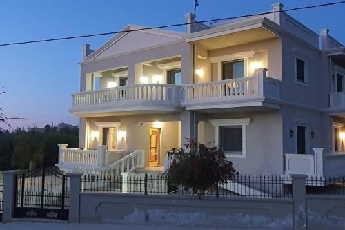 a large white house with a balcony at Olivia in Chania Town