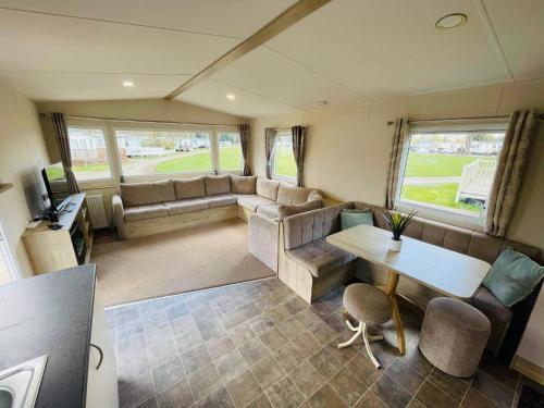 a living room with a couch and a table in a caravan at Lakeside Holiday rentals - Trieste in Great Billing