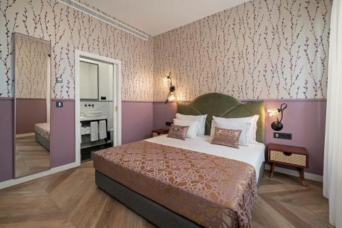a bedroom with a large bed and a bathroom at Madeira Gems Apartments in Funchal