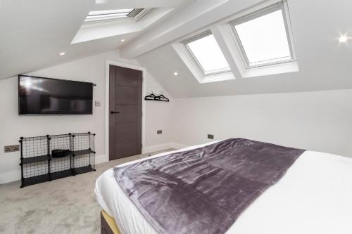 a bedroom with a bed and a tv on the wall at The Old Hotel in York