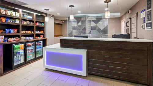 a bar in a store with a purple light at Best Western Plus Raleigh Crabtree Valley Hotel in Raleigh