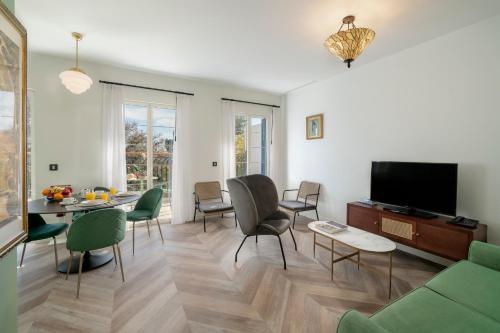 a living room with a couch and a table and chairs at Madeira Gems Apartments in Funchal