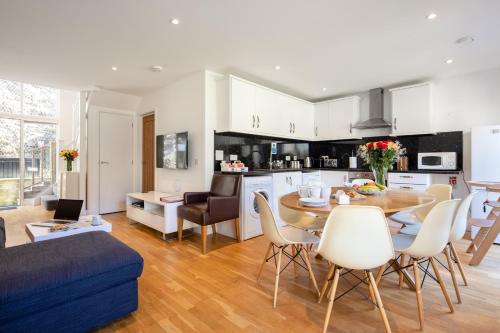 a kitchen and living room with a table and chairs at Cornish Holiday - Bodannon in Porthtowan