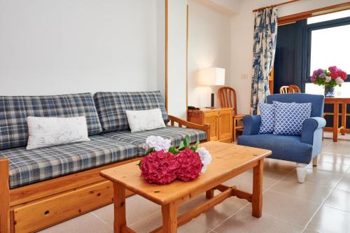 a living room with a couch and a table at Hotel Juan de la Cosa in Santoña