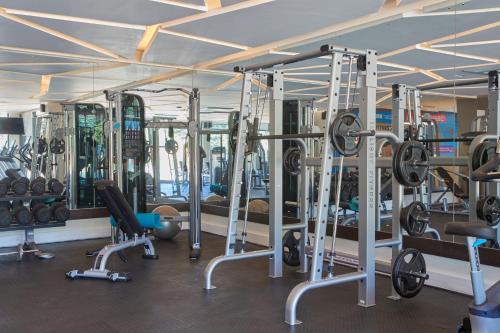 a gym with a lot of machines and weights at The Quorum in Lusaka