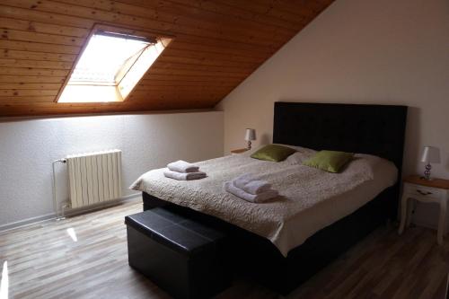 a bedroom with a large bed with towels on it at Penzion Stranny in Stranný
