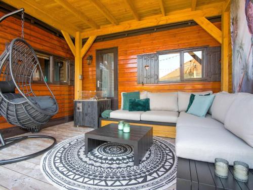 een woonkamer met een bank en een tafel bij Ibiza style chalet in Brouwershaven with lounge terrace in Brouwershaven