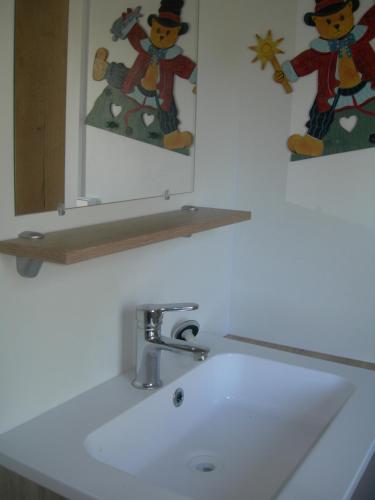 a white bathroom sink with a mirror and a counter top at camping le montourey à fréjus 83600 in Fréjus