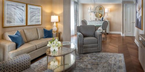 a living room with a couch and a table at Chateau Vaudreuil in Vaudreuil-Dorion