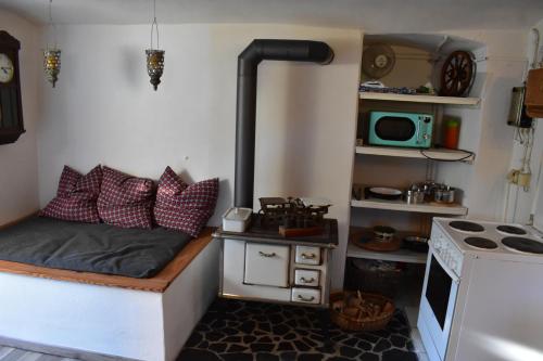 a small room with a bed and a stove at Zimmer Bärbel in Förbau