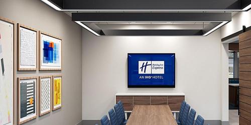 a conference room with a table and blue chairs at Holiday Inn Express & Suites - Harrisonburg University Area by IHG in Harrisonburg
