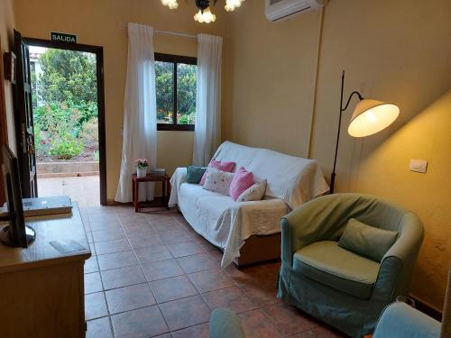 a living room with a couch and a chair at Casa Fátima Valle Gran Rey in Valle Gran Rey