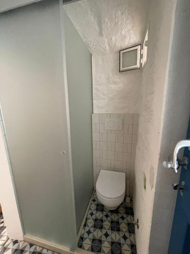 a small bathroom with a toilet and a tiled floor at La Casetta 21 in Polignano a Mare