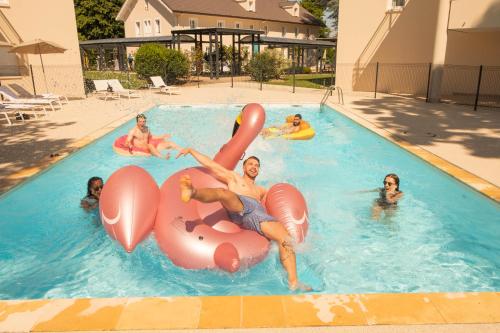 um grupo de pessoas brincando em uma piscina em The Residence Hotel Geneva Airport em Ferney-Voltaire