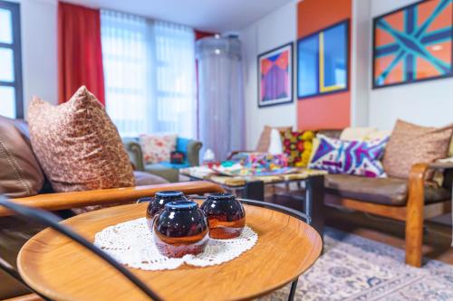 a living room with two vases on a table at Tante ALMA's Bonner Hotel in Bonn