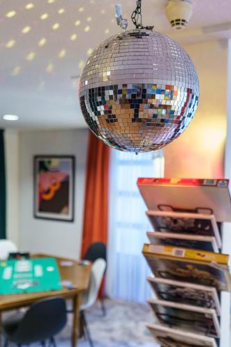 a disco ball hanging over a stack of records at Tante ALMA's Bonner Hotel in Bonn