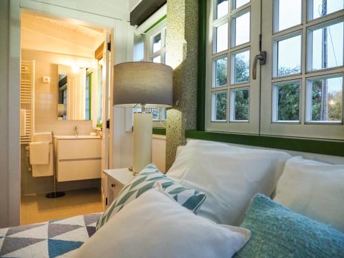 a bedroom with a bed with a mirror and a sink at Casa da Vinha in Arcos de Valdevez