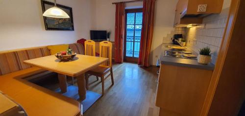 a small kitchen with a table and a table and a dining room at Schlosserhaus Appartements in Wagrain