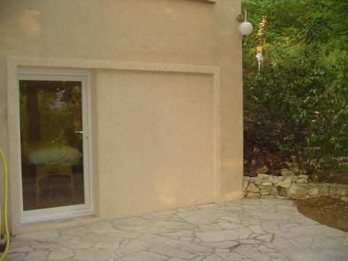 a garage door on a house with a window at La Maison St Gervais in Saint-Gervais