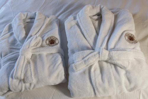 two white gloves sitting on top of a bed at Venckai Venckuose in Venckai