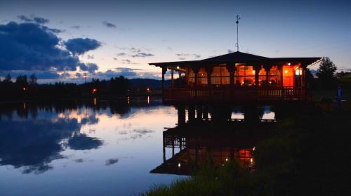 a gazebo on a lake at night at Rybník Dalibor I in Vlcice