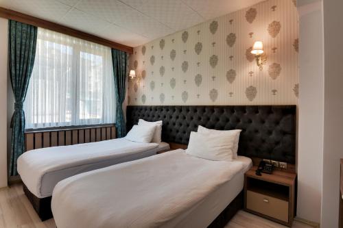 Postel nebo postele na pokoji v ubytování Grande Stella Hotel
