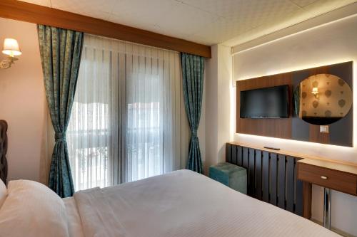 Postel nebo postele na pokoji v ubytování Grande Stella Hotel