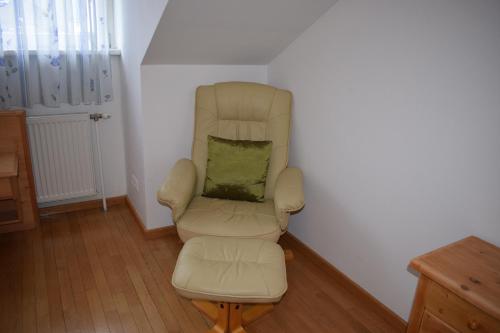 aige chair with a green pillow in a room at Frühstückspension Josefinum in Bad Aussee