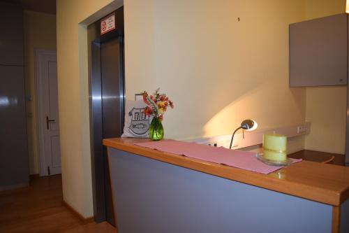 a kitchen with a counter with a vase of flowers on it at Frühstückspension Josefinum in Bad Aussee