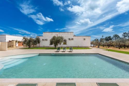 a swimming pool in front of a building at Villa La Paiara by Perle di Puglia in Borgagne