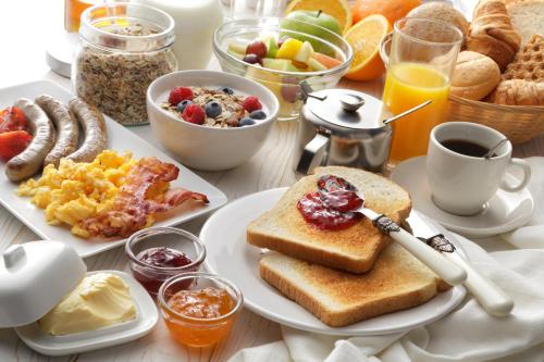 a breakfast table with breakfast foods and drinks at Holiday Inn Express Hotel & Suites Kalispell by IHG in Kalispell