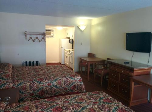 a hotel room with two beds and a flat screen tv at Sea Dunes Oceanfront in Myrtle Beach