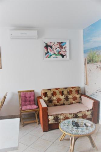 a living room with a couch and a table at Apartman L&P in Fažana
