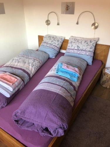 two beds with pillows on top of them in a room at Nid d'abeilles in Tramelan
