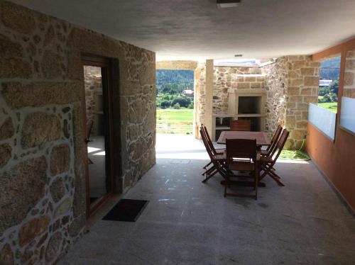 a dining room with a table in a stone building at Casa do Caminho - Ossela in Oliveira de Azemeis