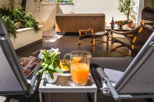 a table with two glasses of orange juice on it at Amaris luxury apartments in Split