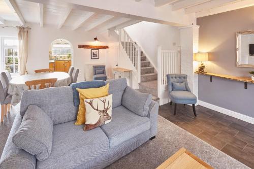 a living room with a couch and a dining room at Host & Stay - Dove Grey, 25 West End in Kirkbymoorside