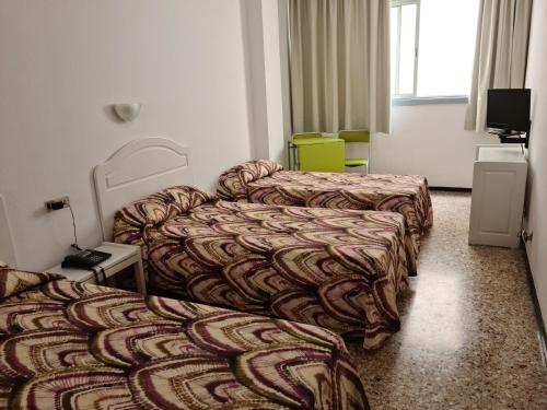 A bed or beds in a room at Apartamentos Catalina Park