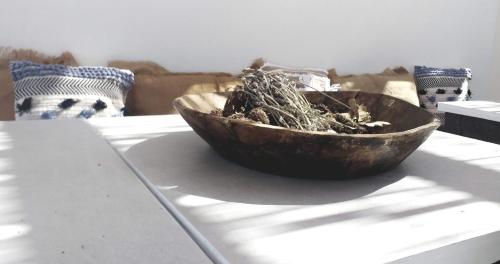 a wooden bowl sitting on top of a table at Anassa Cycladic Village in Galissas