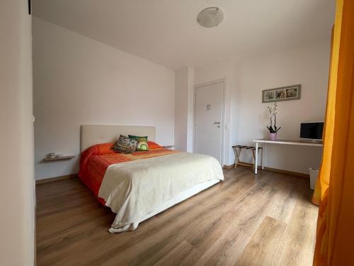 a bedroom with a bed and a wooden floor at Agriturismo Soleada in Ventimiglia