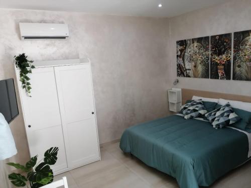 a bedroom with a bed and a white cabinet at B&b Ilary Home in Bari