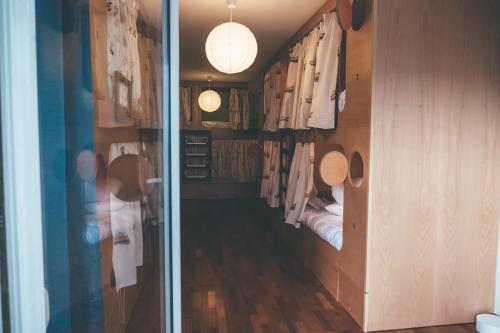 a small room with a hallway with a bed and a hallway at Oportocean Hostel in Matosinhos