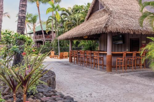 a resort with chairs and tables and a building at Club Wyndham Kona in Kailua-Kona