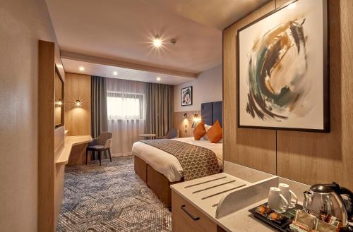 a hotel room with a bed and a desk at Crowne Plaza Reading in Reading
